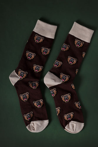 a picture of a pair of socks colored brown with a pattern of bear heads